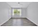 Spacious bedroom with wood-look floors, ceiling fan, large closet, and a window at 288 Crew Ct, Sarasota, FL 34243
