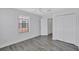 Bright bedroom featuring wood-look floors, a window and double-door closets at 288 Crew Ct, Sarasota, FL 34243
