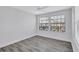 Bright bedroom featuring wood-look floors, ceiling fan, and a window at 288 Crew Ct, Sarasota, FL 34243