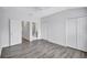 An airy bedroom featuring wood-look flooring, double door closet, and an ensuite bathroom entrance at 288 Crew Ct, Sarasota, FL 34243