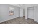 Bright bedroom featuring wood-look floors, ceiling fan, closet, and a window at 288 Crew Ct, Sarasota, FL 34243