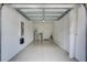 Spacious two car garage with epoxy flooring, water heater, and electric panel at 288 Crew Ct, Sarasota, FL 34243