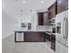 Open kitchen with stainless steel appliances, island with sink and breakfast bar seating at 288 Crew Ct, Sarasota, FL 34243