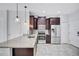 Stylish kitchen featuring granite countertops, stainless steel appliances, and dark wood cabinetry at 288 Crew Ct, Sarasota, FL 34243