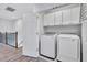Convenient laundry room features a washer, dryer, and ample cabinet space for storage, located upstairs near the bedrooms at 288 Crew Ct, Sarasota, FL 34243