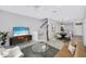 Open-concept living area showcasing modern furnishings, stairs, and access to the dining area at 288 Crew Ct, Sarasota, FL 34243