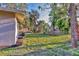 Expansive backyard featuring lush greenery and tropical palm trees creating a private outdoor oasis at 2947 Goodrich Ave, Sarasota, FL 34234