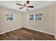 Bedroom with wood floors, neutral paint, a ceiling fan, and natural light from two windows at 2947 Goodrich Ave, Sarasota, FL 34234