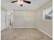 Bedroom featuring tile floors, natural light, and white doors leading to the hallway at 2947 Goodrich Ave, Sarasota, FL 34234