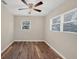 Bedroom with wood floors and natural light from two windows at 2947 Goodrich Ave, Sarasota, FL 34234