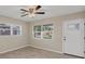 Bright living room with tile floors, ceiling fan and abundant natural light from windows at 2947 Goodrich Ave, Sarasota, FL 34234