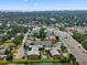 Overhead view of the apartment complex with a pool, a lake, and the Gulf of Mexico in the distance at 2950 Clark Rd # 113, Sarasota, FL 34231