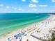 Breathtaking view of a white sand beach meeting turquoise water, scattered with beach umbrellas at 2950 Clark Rd # 113, Sarasota, FL 34231