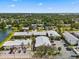 Aerial view of the complex showcasing the buildings, parking, and surrounding residential neighborhood and vegetation at 2950 Clark Rd # 113, Sarasota, FL 34231