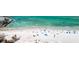 Stunning aerial view showcasing the sandy beach and turquoise water with people enjoying the sunny day at 2950 Clark Rd # 113, Sarasota, FL 34231