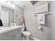 Well-lit bathroom featuring a gray vanity and neutral decor for a clean and modern aesthetic at 2950 Clark Rd # 113, Sarasota, FL 34231