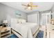 A serene bedroom with light gray walls, white bedding, and a ceiling fan, creating a calming atmosphere at 2950 Clark Rd # 113, Sarasota, FL 34231