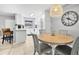 Dining area featuring a modern round table, grey chairs, and a stylish pendant light at 2950 Clark Rd # 113, Sarasota, FL 34231