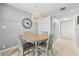 Eat-in dining area with wood table, four chairs, and stylish light fixture at 2950 Clark Rd # 113, Sarasota, FL 34231