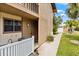 Exterior view of home entrance showcasing white fence, siding, and well-maintained landscaping at 2950 Clark Rd # 113, Sarasota, FL 34231