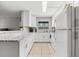 Clean kitchen featuring white cabinets, stone countertops and tile floor for a modern look at 2950 Clark Rd # 113, Sarasota, FL 34231