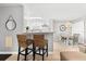 Cozy breakfast bar and kitchen area with stainless steel appliances and view to a bright dining area at 2950 Clark Rd # 113, Sarasota, FL 34231