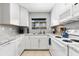 Bright kitchen features granite countertops, white appliances and white cabinets at 2950 Clark Rd # 113, Sarasota, FL 34231