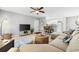 Inviting living room featuring a large sectional, TV area, and breakfast bar with access to the kitchen at 2950 Clark Rd # 113, Sarasota, FL 34231