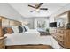 Comfortable primary bedroom with a ceiling fan and a dresser at 2950 Clark Rd # 113, Sarasota, FL 34231