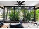 Screened lanai with patio furniture and lush tropical landscaping views at 2950 Clark Rd # 113, Sarasota, FL 34231