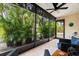 Relaxing screened-in patio with comfortable seating and lush greenery at 2950 Clark Rd # 113, Sarasota, FL 34231
