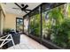 Enclosed patio featuring comfortable seating and serene views of tropical foliage at 2950 Clark Rd # 113, Sarasota, FL 34231