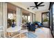 Inviting screened-in patio with stylish seating and a view of swaying palm trees at 2950 Clark Rd # 113, Sarasota, FL 34231