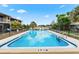 Community pool with clear water, surrounded by lush landscaping and comfortable seating areas at 2950 Clark Rd # 113, Sarasota, FL 34231