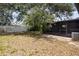 View of the backyard and screened patio with an exterior A/C unit at 3505 27Th W Ave, Bradenton, FL 34205