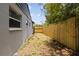 Side backyard featuring a wooden fence and exterior view of the home at 3505 27Th W Ave, Bradenton, FL 34205