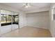 Well-lit bedroom with tile flooring, a ceiling fan, a large closet, and glass sliding doors to the screened patio at 3505 27Th W Ave, Bradenton, FL 34205