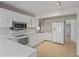 Bright kitchen with white cabinetry, stainless steel microwave, and tile flooring at 3505 27Th W Ave, Bradenton, FL 34205