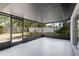 This is an enclosed screened patio with view of the partially-shaded backyard at 3505 27Th W Ave, Bradenton, FL 34205