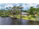 Waterfront home featuring a private dock, screened pool, and lush tropical landscaping at 4311 52Nd E St, Bradenton, FL 34208