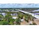 Aerial view showcases the property's proximity to the river and bridge, surrounded by trees at 4311 52Nd E St, Bradenton, FL 34208