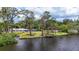 Scenic waterfront property boasting a private dock, screened enclosure and verdant landscaping at 4311 52Nd E St, Bradenton, FL 34208