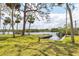 Expansive backyard with lush greenery, mature trees, and waterfront access, creating a serene outdoor oasis at 4311 52Nd E St, Bradenton, FL 34208