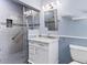 Updated bathroom featuring a glass shower, modern vanity and blue accents at 4311 52Nd E St, Bradenton, FL 34208