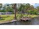 Picturesque waterfront property featuring a wooden dock and spacious yard, perfect for outdoor living and recreation at 4311 52Nd E St, Bradenton, FL 34208