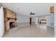 Spacious living room with stone fireplace and access to a sunroom with sliding glass doors at 4311 52Nd E St, Bradenton, FL 34208