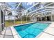 Refreshing blue pool surrounded by a screened enclosure and lush backyard at 4311 52Nd E St, Bradenton, FL 34208