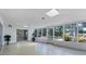 Bright sunroom with terrazzo flooring, skylights, and large windows with a peaceful view at 4311 52Nd E St, Bradenton, FL 34208