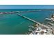 This aerial view showcases the bridge, boats, and nearby neighborhood at 4420 101St W St, Bradenton, FL 34210