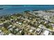 Stunning aerial view showcases a waterfront community with homes near the coast and beautiful blue ocean at 4420 101St W St, Bradenton, FL 34210